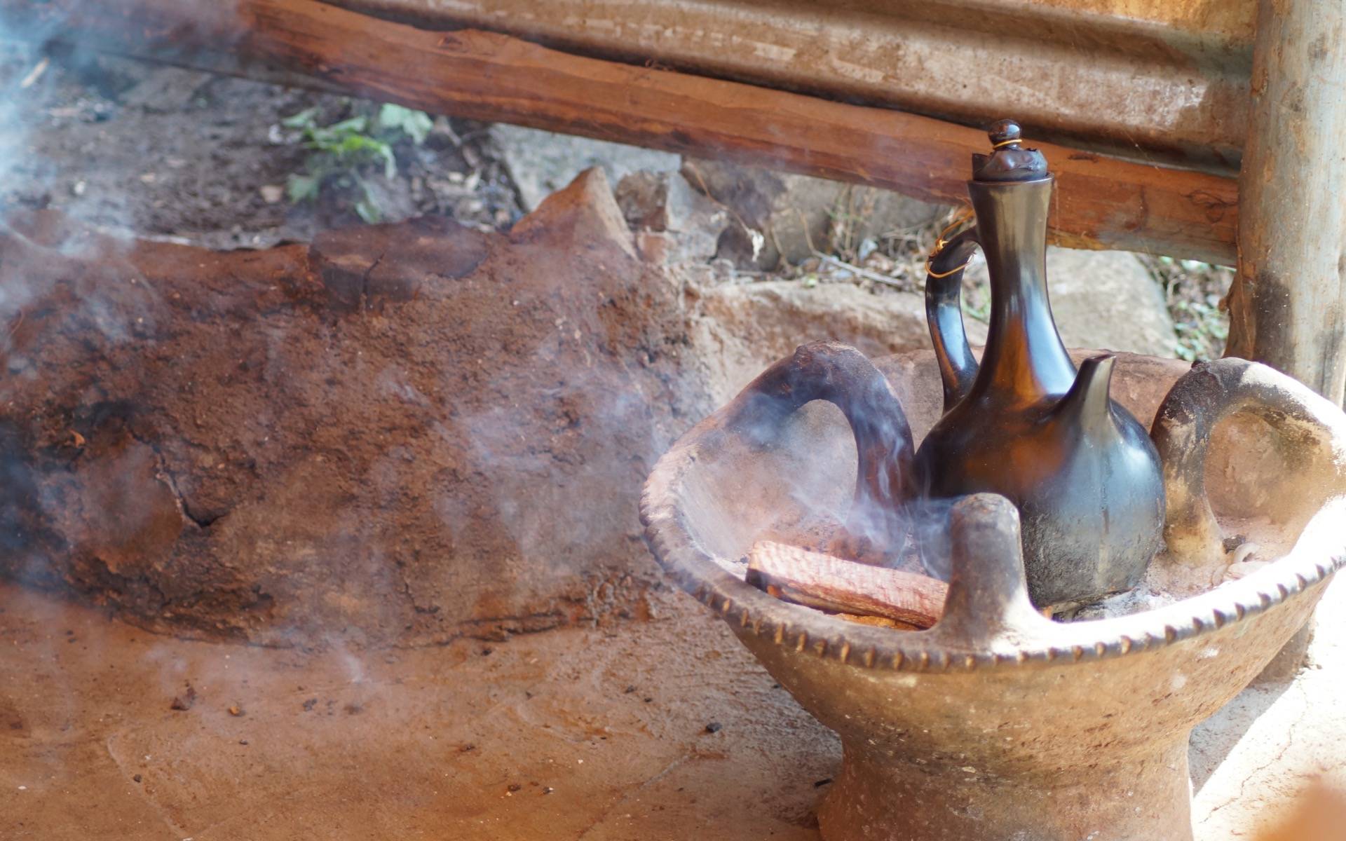 In Äthiopien wird in einer Tonkanne auf einer steinernen Form mit Kohle Kaffee zubereitet.